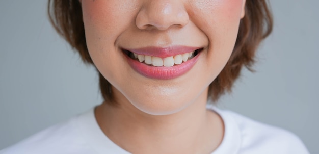азиатская женщина улыбается с красивым зубом для стоматологического здравоохранения