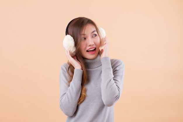 Asian woman smiling with ear muffs