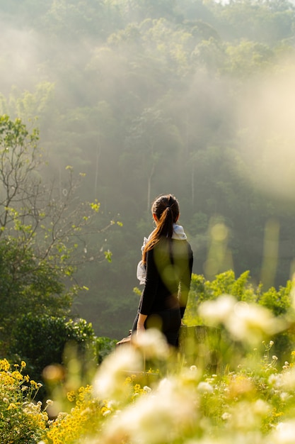 Asian woman standing soulful atmosphere 
in Chrysanthemum field