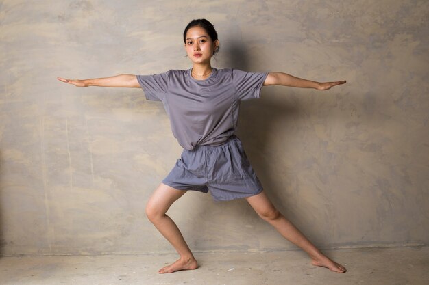 Asian woman standing at yoga pose