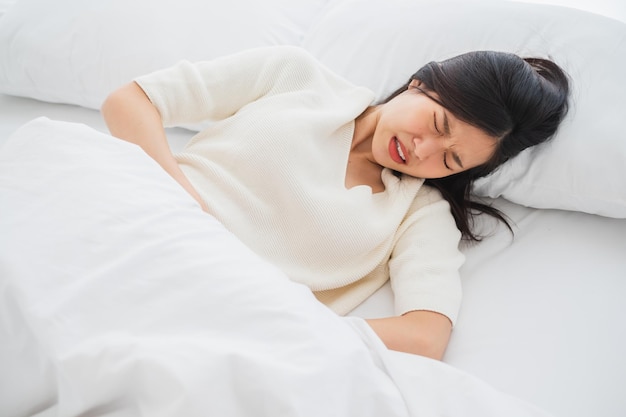 asian woman stomachache feel pain for period concept