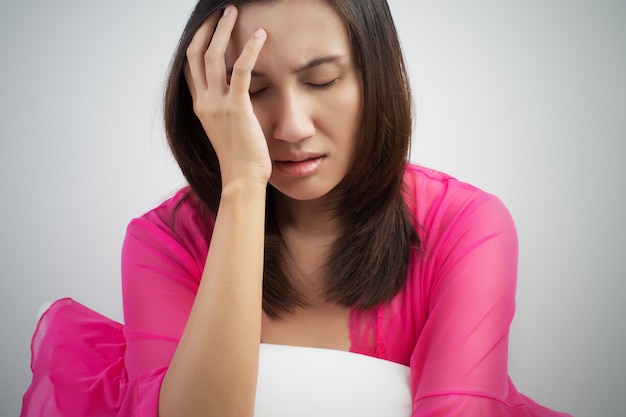 Asian woman suffering from insomnia, having headache in bed