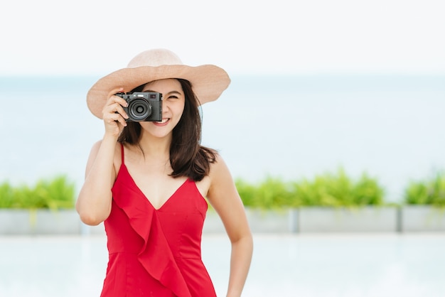 Asian woman taking a photo during her vacation