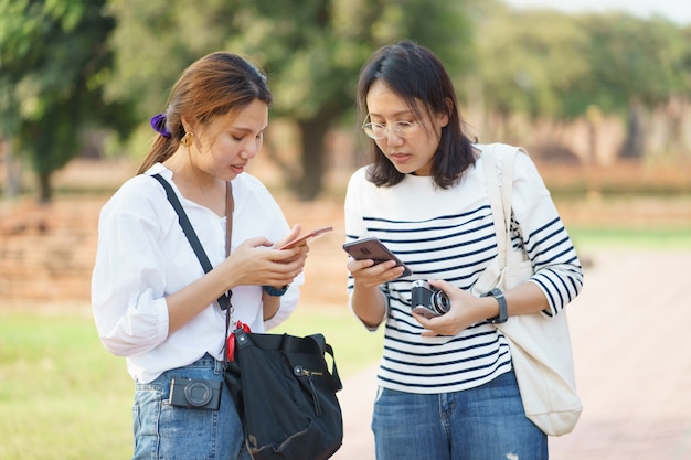 Asian woman taking photograph and traveling