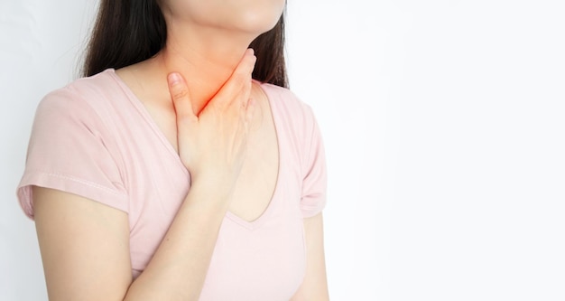 Asian woman touch her throat with pain sore throat and a sickness