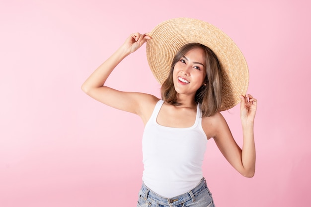 Asian woman tourists wear summer clothes and wide-brimmed straw hats