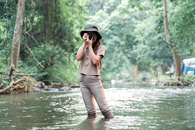 Asian woman travel and camping alone at natural park in Thailand. Recreation and journey outdoor activity lifestyle.