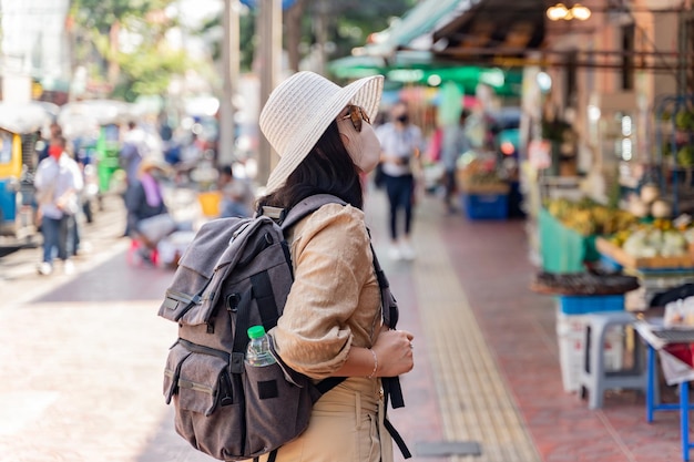 Asian woman travel in the city alone. Young tourist girl in Bangkok Thailand on summer holiday.