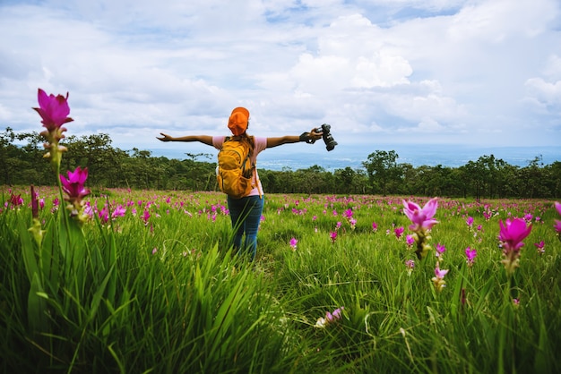 Asian woman travel nature. Travel relax. Photography Cucumber sessilis flower field.