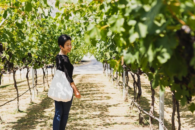 Asian woman traveling Asian standing in beautiful Vineyard