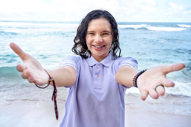 Asian woman traveling on the beach open hand