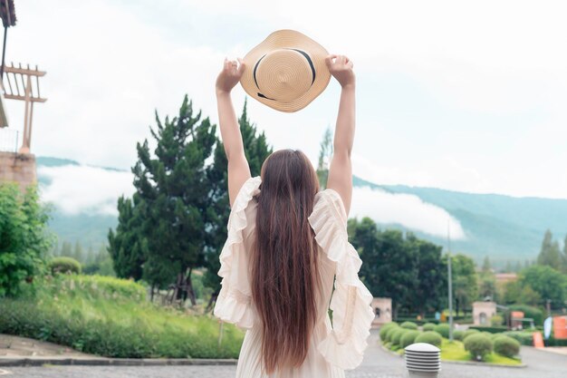 Asian woman traveling at the old town italy styleAlone travelLifestyle of single girlView mountain with fog