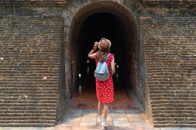 Asian woman traveller in white dress travel in wat Umong temple in Chiang mai city Tahiland