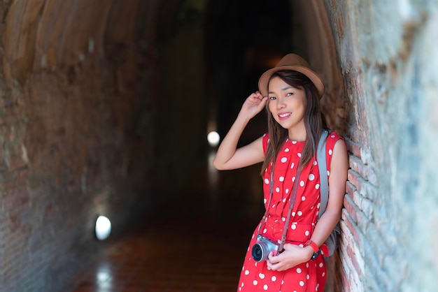 Asian woman traveller in white dress travel in wat Umong temple in Chiang mai city Tahiland