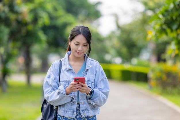 Asian woman use smart phone in the park