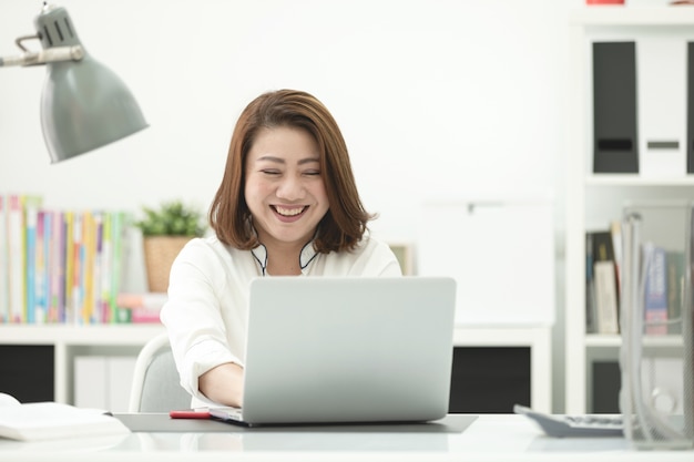 Asian woman using laptop at home