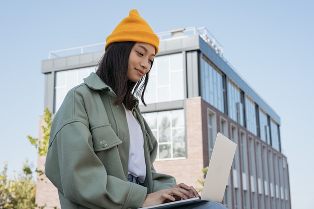 Asian woman using laptop searching online