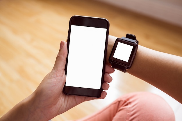 Asian woman using smart watch and phone