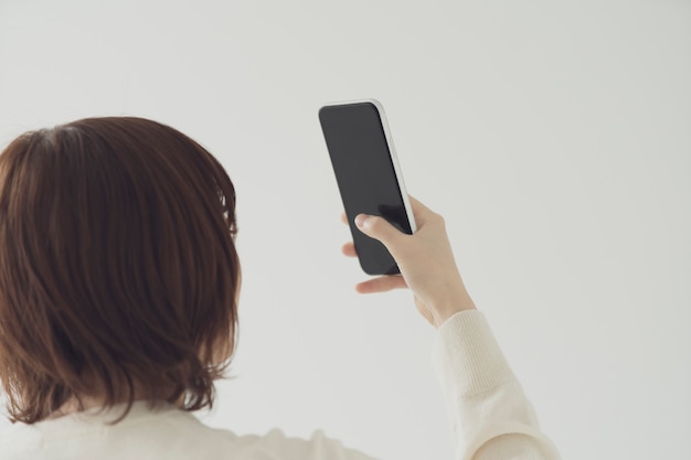 Asian woman using smartphone and taking photos and using applications