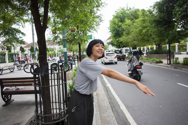 Asian woman waiting outside for public transport