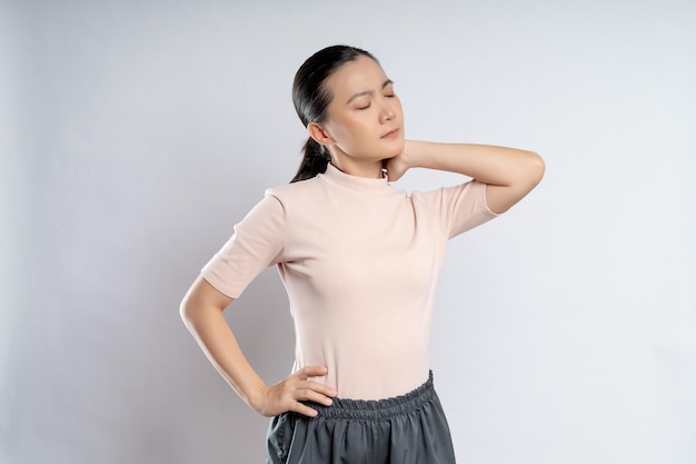 Asian woman was sick with body pain standing isolated on white background