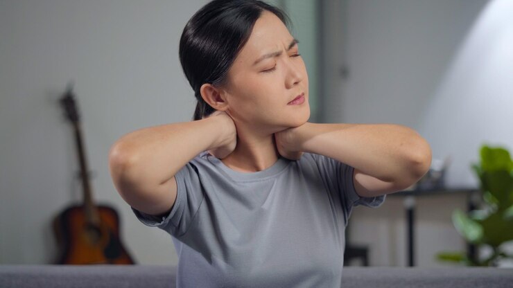 Photo 아시아 여성은 집 거실에 있는 소파에 앉아 몸을 만지는 몸살로 아팠다