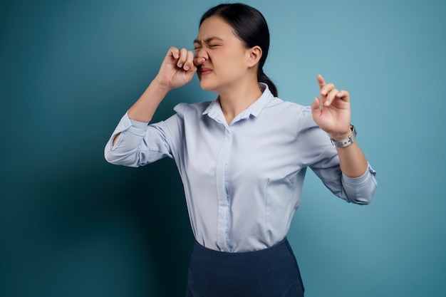 Asian woman was sick with fever isolated on blue.