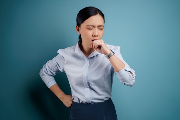 Asian woman was sick with fever isolated on blue.