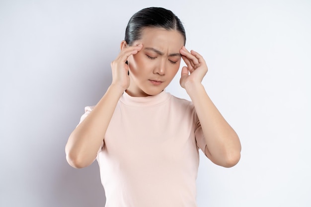 Asian woman was sick with headache standing isolated on white background