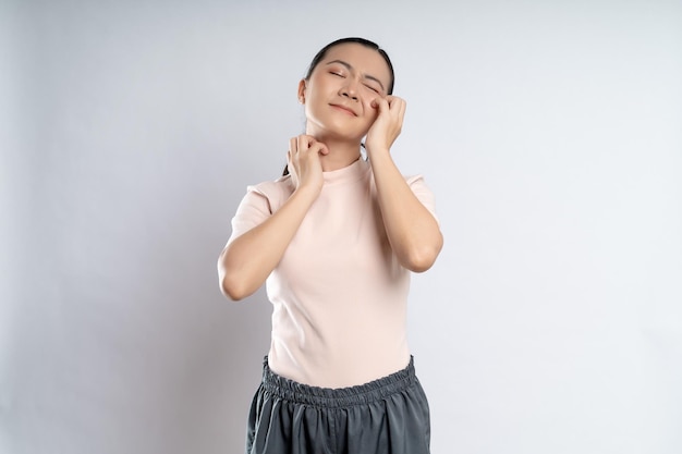 Asian woman was sick with irritate itching her skin standing isolated on white background