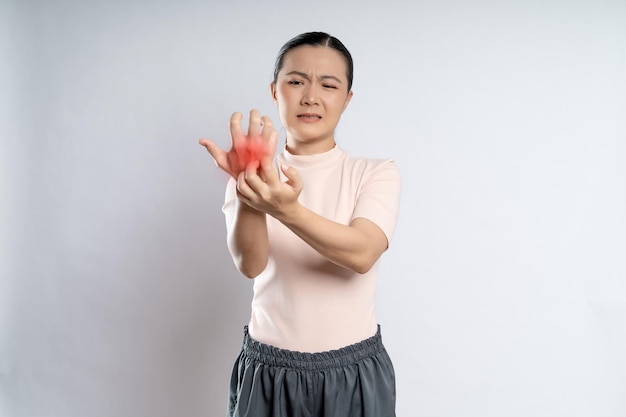 Asian woman was sick with irritate itching her skin with red spot standing isolated on white background