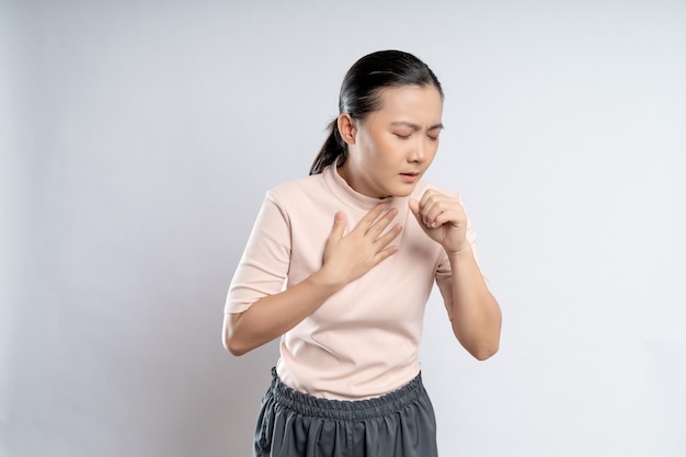 Asian woman was sick with sore throat standing isolated on white background