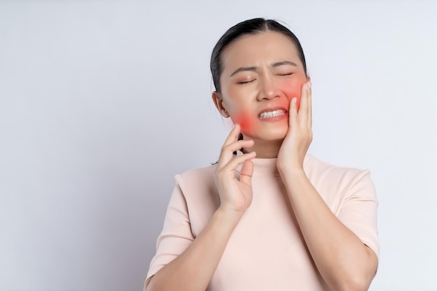 Asian woman was sick with toothache standing isolated on white background