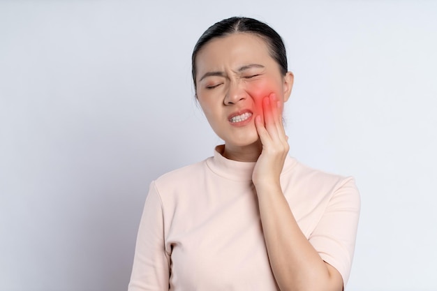 Asian woman was sick with toothache standing isolated on white background