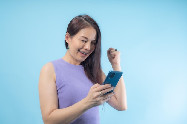 Asian woman was surprised and excited about the smartphone