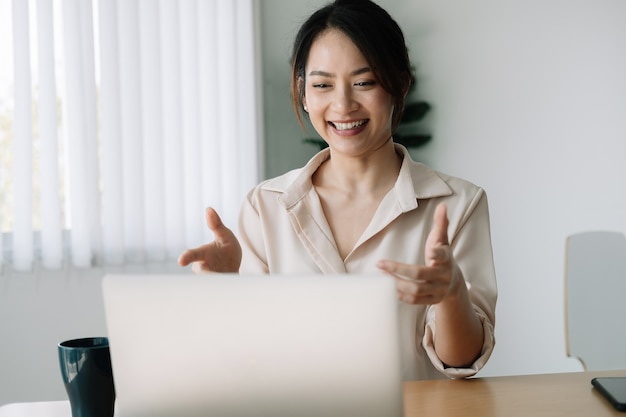 Photo asian woman watching webinar on laptop computer