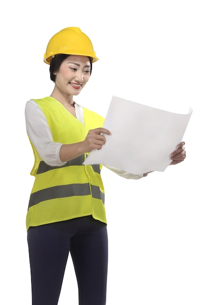 Asian woman wear had hat and safety vest looking blueprint