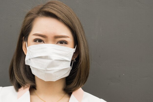 Asian woman wear protective face mask in pollution city with coughing., copy space for text