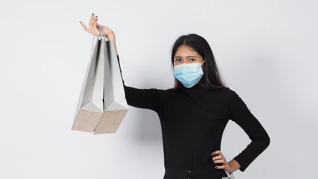 Asian woman wearing face mask hold shopping bag