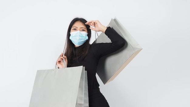 Asian woman wearing face mask hold shopping bag