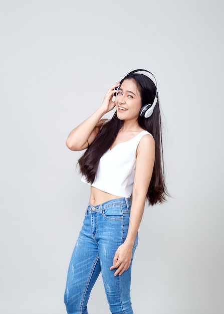 Asian woman wearing headphones dancing active