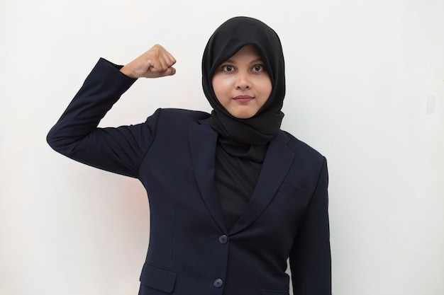 Asian woman wearing hijab happy and excited celebrating victory expressing big success power energy and positive emotions Celebrates new job joyful