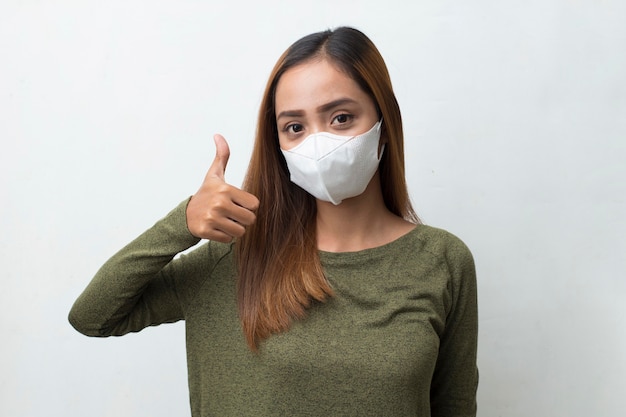 Asian woman wearing medical face mask to protection corona virus covid19 posing on white