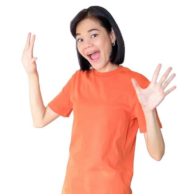 An Asian woman wearing an orange shirt poses with a happy wow face.