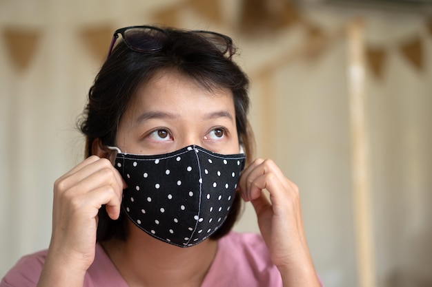 Asian woman wearing protective mask on her face