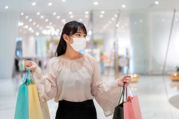 Asian woman wearing protective mask at the mall