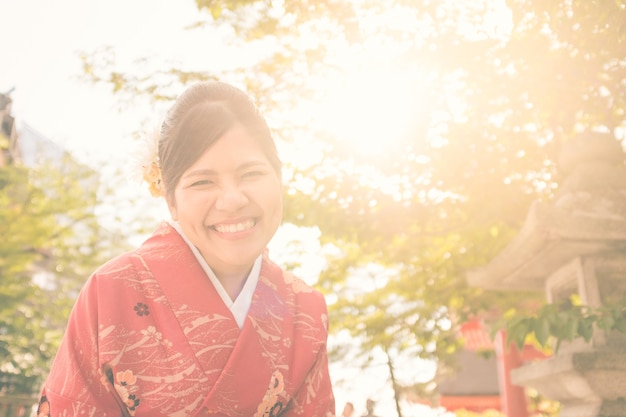 Asian woman wearing red kimono in kyoto