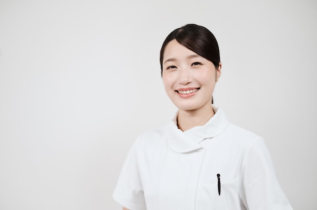 Asian woman in a white coat