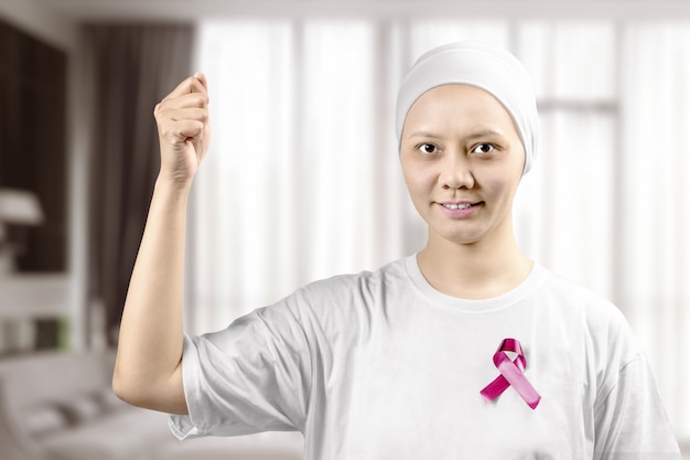 asian woman in a white shirt with a pink ribbon on the home
