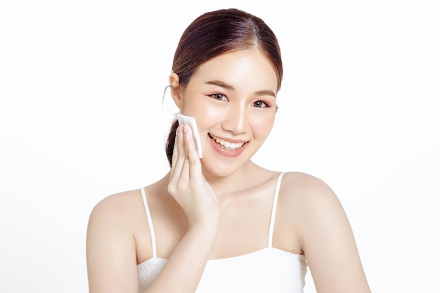 Asian woman with a beautiful face and fresh skin cleaning the makeup on white isolated background